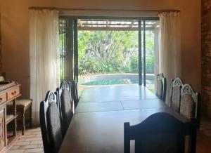a long table with chairs and a large window at Mountain Rest in Waterfall