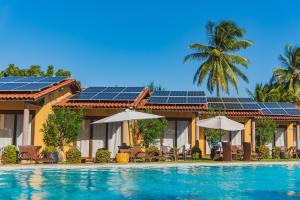 a house with solar panels on top of a swimming pool at Almai Cumbuco in Cumbuco
