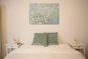 a bedroom with a bed with a painting on the wall at La Casetta in Catania