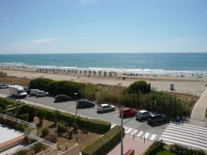 a parking lot next to a beach with cars parked at Playamar 231 in Alcossebre