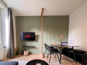 Et tv og/eller underholdning på Appart'Hôtel Le Valdoie - Rénové, Calme & Netflix