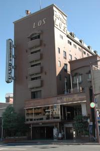 a building with a sign on the side of it at Hotel Los Inn Kochi in Kochi