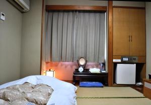 Postel nebo postele na pokoji v ubytování Hotel Los Inn Kochi