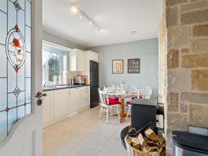 a kitchen with a table and a dining room at An Teachin Corcra in Rosmuck