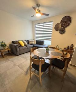 a living room with a table and a couch at Apartamento Hospicio Cabañas in Guadalajara