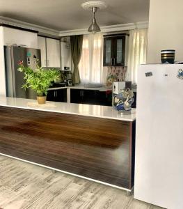 a kitchen with a white refrigerator in a room at Ahmet teacher's villa, 6 minutes from the airport in Arnavutköy