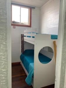 a bunk bed in a tiny house with a window at Hostal el Idilio in Cartagena