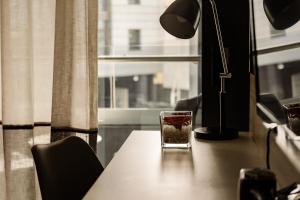 a glass sitting on a table next to a window at be.HOTEL in St. Julianʼs