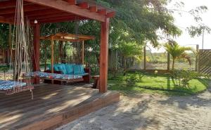 a porch with a swing in a yard at Dalas Village in Marau