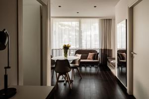 a living room with a table and chairs at be.HOTEL in St. Julianʼs