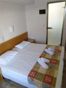 a hotel room with a bed with towels on it at Nafsika Hotel in Rhodes Town