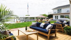a patio with a blue couch and a table at Wylder Hotel - Tilghman Island in Saint Michaels