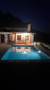 una piscina frente a una casa por la noche en Rural ca´s Pelut, en Tàrbena