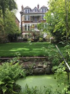 a large house with a garden in front of it at High View Large Luxury House in Norwood