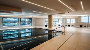 an office with a pool in the middle of a room at be.HOTEL in St. Julianʼs