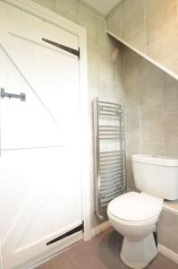 a bathroom with a white toilet and a shower at Coquetdale Cottage in Rothbury, Nr National Park in Rothbury