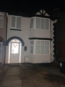 a white house with a door and a window at Calm residential house in Wyken