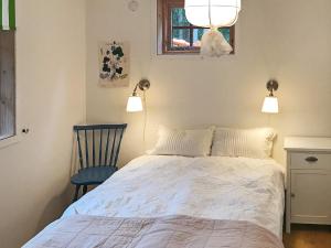 sypialnia z łóżkiem, krzesłem i światłami w obiekcie Holiday home Ånimskog w mieście Ånimskog