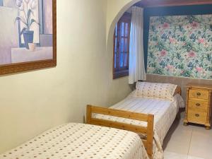 two twin beds in a room with a window at Apartamentos Islas Canarias in Icod de los Vinos