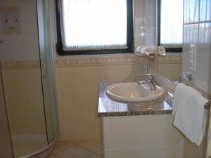 a bathroom with a sink and a shower at Apartments Villa Eden in Preko