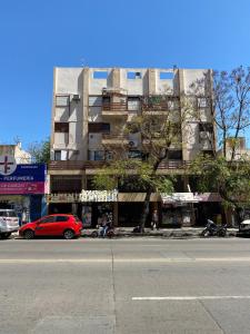 a red car parked in front of a building at Pacífico Il in Cordoba