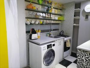a kitchen with a washing machine and a sink at Mini independent apartment in Lima