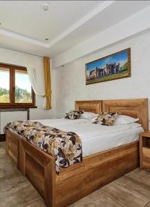 a bedroom with a large wooden bed in a room at Bački dvor 