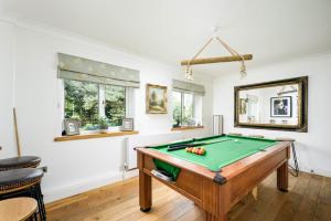 a billiard room with a pool table at Cheerful 7-bedroom house with hot tub sleeps 24 in Iron Acton