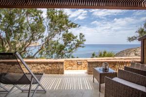 a patio with a view of the ocean at Relais Isole del Sud in Lampedusa