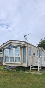 a tiny house is parked in a yard at Caravan 6 berth in Ingoldmells