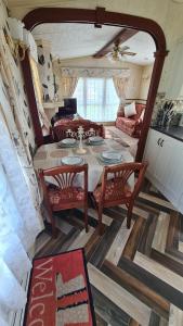 a living room with a table and chairs and a couch at Caravan 6 berth in Ingoldmells