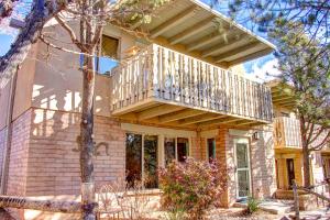 a house with a balcony on top of it at Beautiful Santa Fe residence blocks from the plaza and close to ski basin in Santa Fe