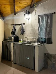 a kitchen with a sink and a counter top at Cabaña tierra verde in Yala