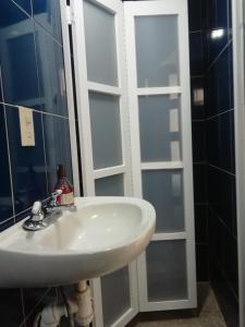 a bathroom with a sink and a glass door at Casa Caracol Guanajuato in Guanajuato +15 photos