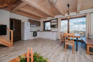 a kitchen and dining room with a table and chairs at Gazdov dvor in Dolný Kubín