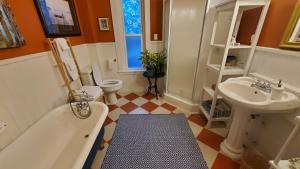 a bathroom with a tub and a toilet and a sink at The Lark & Loon Inn in Annapolis Royal +37 photos