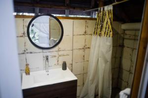 a bathroom with a sink and a mirror at 8 Caminos Glamping in Carmen de Apicalá