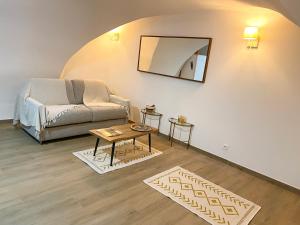 a living room with a couch and a table at L'AGACHON LA CIOTAT VIEUX PORT in La Ciotat