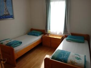 Postel nebo postele na pokoji v ubytování APARTMAN PALMA