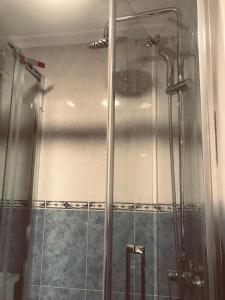 a shower with a glass door in a bathroom at Beach apartment-VillaJoyosa, north Alicante in Villajoyosa