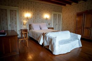 1 dormitorio con 1 cama y suelo de madera en maison bourgeoise, en Rouffignac
