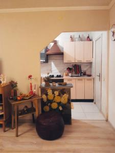 a room with a kitchen with a table and a counter at Apartamentai in Tauragė