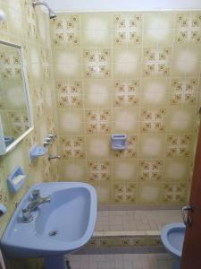 a bathroom with a sink and a shower at Chalet los Abuelos in La Falda