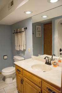 a bathroom with a sink and a toilet and a mirror at The Bavarian Village Resort in Branson