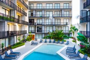 an apartment building with a swimming pool and patio furniture at Urban Tower A211 in Playa del Carmen