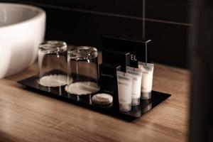 a black tray with candles and glasses on a table at be.HOTEL in St. Julianʼs
