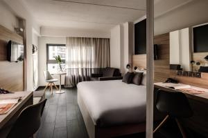 a hotel room with a bed and a desk at be.HOTEL in St. Julianʼs