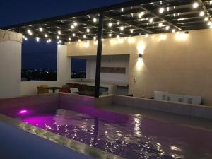 a swimming pool with lights on top of a house at New apartment with all services and pool Marcos #1 in Isla Mujeres