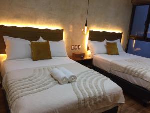 two beds in a hotel room with towels on them at New apartment with all services and pool Marcos #1 in Isla Mujeres +41 photos