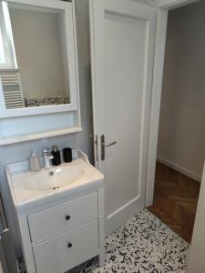 a bathroom with a white sink and a mirror at Specious and newly decorated at Bacvice beach in Split